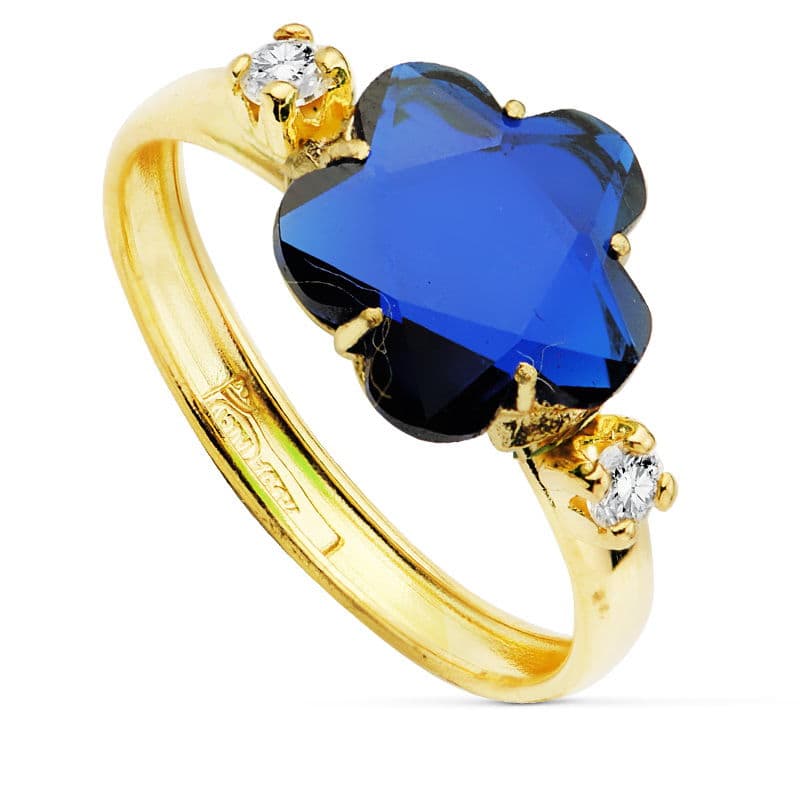 18K SORTIJA ORO AMARILLO CON CIRCONITA AZUL FORMA FLOR 10X10 MM.
